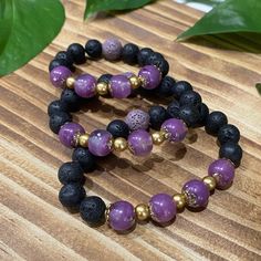 "These one of a kind Diffuser Bracelets are made with Volcanic Lava Rock beads which are a naturally porous stone perfect for absorbing your favorite essential oils. This series boasts shimmering purple hand made resin beads, gold spacer beads, and black lava rock beads with one purple lava rock bead to match. The resin beads glow a gentle purple after being exposed to sunlight or other bright lights.  Aromatherapy is a natural way to increase feelings of health and wellbeing.  Handcrafted resin beads are created individually with UV resin, mica, alcohol inks and tints, some with natural black sand and ocean pebbles, glow in the dark pigments, gold leaf flakes or gold stone chips.  These bracelets are on a stretchy elastic .8mm cord. Measure your wrist and add .5\" for snug fit or 1\" for Meditation Bracelets With Natural Lava Stones, Healing Lava Stone Beaded Bracelets, Hand-strung Lava Stone Bracelets For Gift, Hand-strung Lava Stone Bracelets As Gift, Hand-strung Lava Stone Bracelet For Gift, Adjustable Lava Stone Stretch Bracelet Gift, Bohemian Lava Stone Bracelets For Gift, Healing Lava Stone Bracelets With Gemstone Beads, Spiritual Lava Stone Stretch Bracelet With Natural Stones