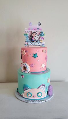 there is a three tiered cake with donuts on the top and other decorations