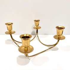 a gold candelabra with five candles on it's sides and one candle in the middle