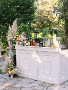 an outdoor bar with bottles on it