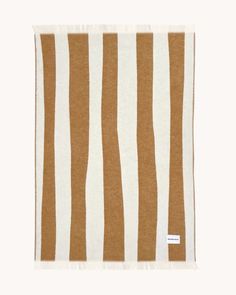 a brown and white striped towel on a white background