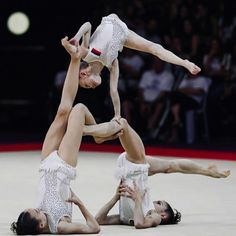 two women doing acrobatic tricks on the floor