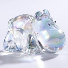 a glass hippo laying down on its side