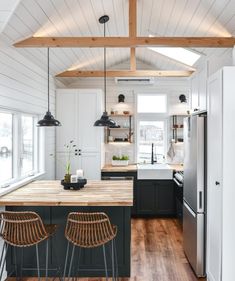 a kitchen with wooden floors and white walls