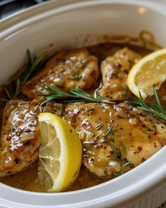 chicken with lemon and rosemary in a white crock pot