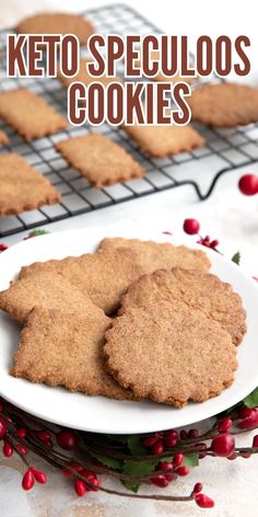 two cookies on a plate with pomegranates in the background and text overlay that reads keto speculoos cookies