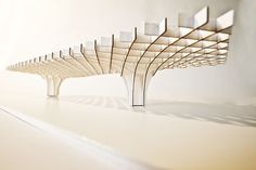 an architectural model of a bridge made out of wood and white tiles on the floor