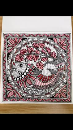 an intricately designed card with red and black designs on the front, featuring two birds