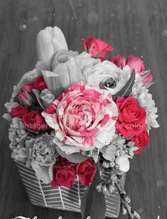 an arrangement of flowers in a basket with the words happy mother's day