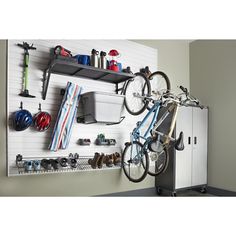 there is a bike hanging on the wall next to a rack with hats and other items