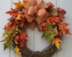 a wreath with autumn leaves and acorns