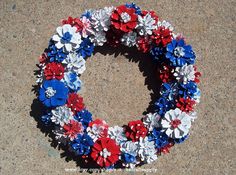 a wreath made out of red, white and blue flowers