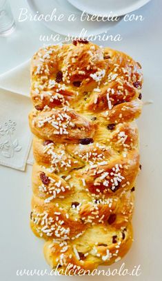 some bread is on a white plate and has sprinkled with sesame seeds in it