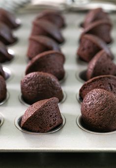 chocolate cupcakes are lined up in a muffin tin