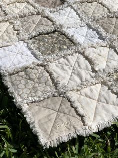 an old quilt is laying in the grass