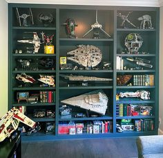 a room filled with lots of toys and bookshelves full of star wars action figures