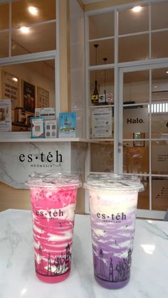 two ice cream cups sitting on top of a counter