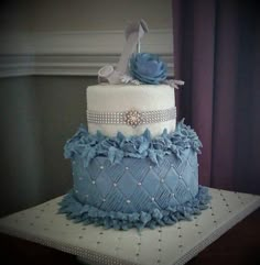 a blue and white wedding cake with high heels on top