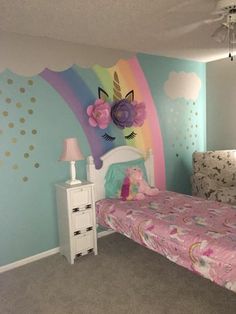 a child's bedroom decorated in pastel colors with unicorns and flowers on the wall