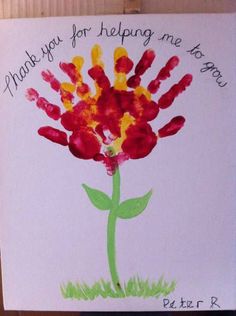 a child's handprinted card with a flower on it