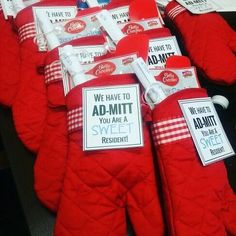 several red mitts with signs on them sitting on a table next to each other