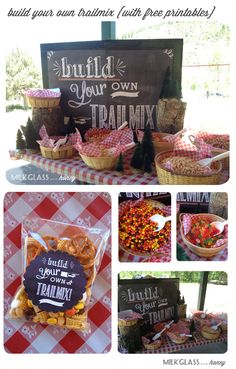 a table topped with lots of food and candy bar signs next to a sign that says build your own trail mix