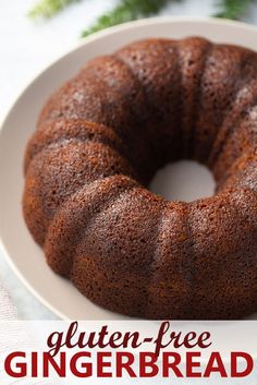 a bundt cake on a white plate with the words gluten - free gingerbread