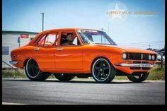 an orange car is parked on the street