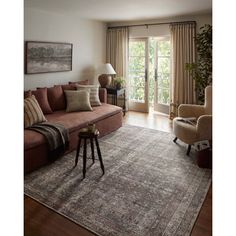 a living room filled with furniture and a large rug