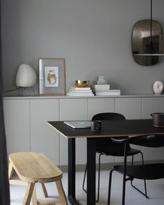 a dining room table and chairs in front of a mirror