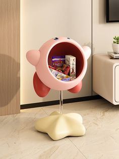 a pink flower shaped shelf with cereal in it's center and some other items inside