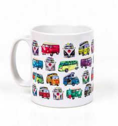 a white coffee mug with colorful bus images on the front and sides, sitting on a white surface