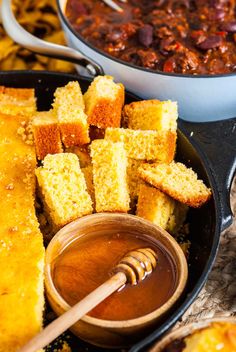 baked cornbreads with chili and dipping sauce in a bowl on the side, next to bread sticks