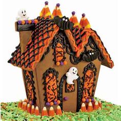 a gingerbread house decorated with candy and sprinkles for the halloween season