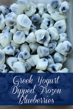 greek yogurt dipped frozen blueberries in a glass container with text overlay