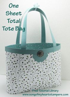 a white bag with green trim and a button on the side that says, one sheet total tote bag