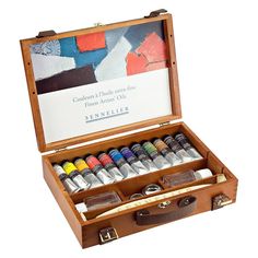 an open wooden box filled with watercolors