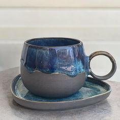 a cup and saucer sitting on a plate