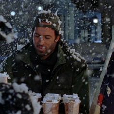 a man sitting at a table covered in snow