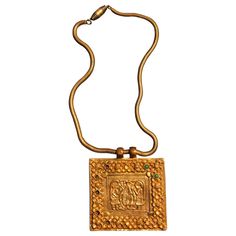 A gilt bronze necklace with chain and a square plaque on the subject of "Adam and Eve in the Garden of Eden" with apple tree in the center, designed and made by Line Vautrin in her early career circa 1938/39. This piece is likely to be cast from the original mold with its sharp and clear lines, when closely compared to the casting published on page 29 of the book Line Vautrin: Sculptor, Jeweler, Magician by Line Vautrin and Patrick Mauries; Thames and Hudson. The chain is also identical to the p Line Vautrin Jewelry, Line Vautrin, Bronze Dragon, The Garden Of Eden, Bronze Bracelets, Modern French, French Jewelry, Bronze Earrings, Bronze Necklace