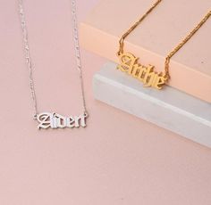 Personalized Christmas His & Hers Jewelry Gifts: Silver Name Plate Old English Font Necklace is the perfect gift for Valentine's Day, Christmas, birthday, anniversary for her, girlfriend, wife, him, boyfriend, husband. Any text with up to 9 characters.~~~~~~~~~~~~~~~~ ~~~~~~~~~~~~~~~~~~~ ★INFO ABOUT THIS ITEM:Material: Sterling Silver 925 / 18K Gold Plated Sterling Silver 925 / Gold Vermeil Plated Sterling Silver 925Thickness: 1.1mm / 0.04"Measurements: 11mm x 35.30mm / 0.43" x 1.39"Chain le Anniversary Gift Name Necklace With Hallmark, Silver Name Necklace For Valentine's Day Gift, Mother's Day Gift Charm Necklace With Nameplate, Mother's Day Nameplate Charm Necklace Gift, Mother's Day Nameplate Charm Necklace, Mother's Day Gift Nameplate Charm Necklace, Name Charm Necklace For Anniversary, Name Charm Necklace For Anniversary Gift, Name Charm Necklaces As A Gift For Anniversary