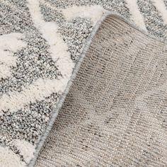 a close up view of a gray and white rug