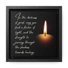 a lit candle with a quote on it