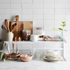 the kitchen counter is cluttered with utensils and other cooking supplies on it