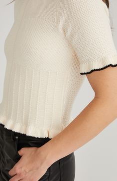 Contrast trim highlights the gentle ruffles at the sleeves and hem of this refined mixed-stitch top. Crewneck Short sleeves 100% cotton Machine wash, dry flat Imported Knit Ruffle Top With Crew Neck, Knit Crew Neck Top With Ruffles, Knit Top With Ruffles And Crew Neck, Ruffled Crew Neck Knit Top, Crew Neck Knit Top With Ruffles, Chic Ruffled Crew Neck Knit Top, Chic Crew Neck Ruffle Knit Top, Chic Crew Neck Knit Top With Ruffles, Chic Crew Neck Tops With Ruffle Hem