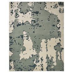 an area rug with green and white paint splattered on it