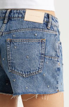 Glittering rhinestones lend a cool retro-inspired vibe to these laid-back cutoff shorts made from nonstretch denim with frayed hems. 3 1/2" inseam; 27" leg opening; 11" front rise; 14" back rise (size 29) Zip fly with button closure Five-pocket style 100% cotton Machine wash, dry flat Imported Asian Owned/Founded Ladies Denim, Purple Jeans, Denim Inspiration, Cutoff Shorts, Embellished Denim, Purple Shorts, Denim Cutoff Shorts, Purple Rhinestone, Denim Cutoffs