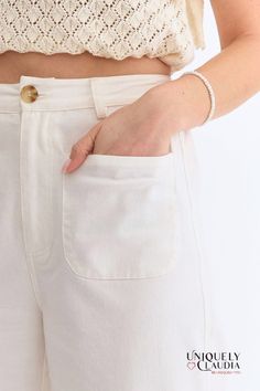 The Kelly Off-White Culotte Pants are high-waisted with a flattering wide-leg silhouette. They feature convenient front pockets and chic faux pockets at the back, adding a touch of sophistication. The front zipper closure and belt loops offer a versatile fit, while the lightweight, woven fabric ensures comfort without compromising on style. These non-sheer pants are unlined, making them perfect for any season. - Unlined - 97% Cotton, and 3% Spandex - Wash Cold. Do Not Bleach. Line Dry. - Importe White Pants With Welt Pockets For Summer, Cream Bottoms With Side Pockets For Work, Workwear Cream Bottoms With Side Pockets, White Wide Leg Bottoms With Side Pockets, Chic Summer Wide Leg Pants With Side Pockets, Wide Leg Pants With Pockets For Day Out, Chic Wide Leg Pants With Side Pockets For Spring, Chic High-waist Bottoms With Patch Pockets, High Waist White Pants With Belt Loops