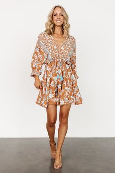 Brown Floral Print V-neck Dress, Brown V-neck Dress With Ruffle Hem, Beige Mini Boho Dress For Vacation, Beige Boho Mini Dress For Vacation, Long Sleeve Mini Dress With Ruffle Hem For Vacation, Brown Ruffle Hem Dress For Vacation, Boho Mini Dress With Boho Print For Brunch, Mini Boho Dress With Boho Print For Brunch, Mini Boho Dress For Brunch