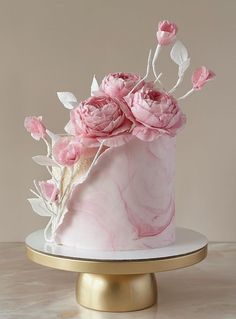 a pink marble cake with flowers on top